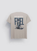 Camiseta mocca Never Runs Out of Fuel — vista trasera con serigrafía mujer en bicicleta y texto FUEL en azul marino, Crystal Peppers