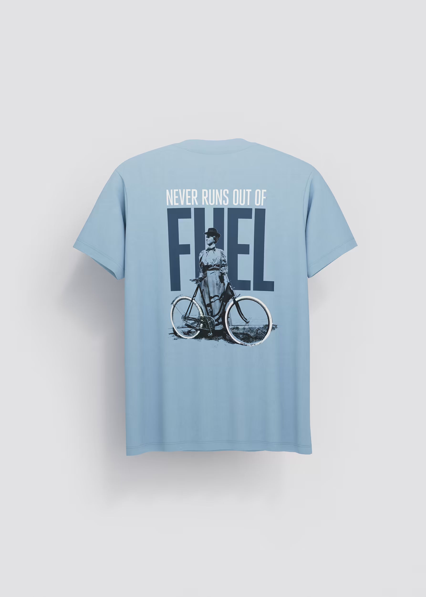 Camiseta azul celeste Never Runs Out of Fuel — vista trasera con serigrafía mujer en bicicleta y texto FUEL en azul marino, Crystal Peppers