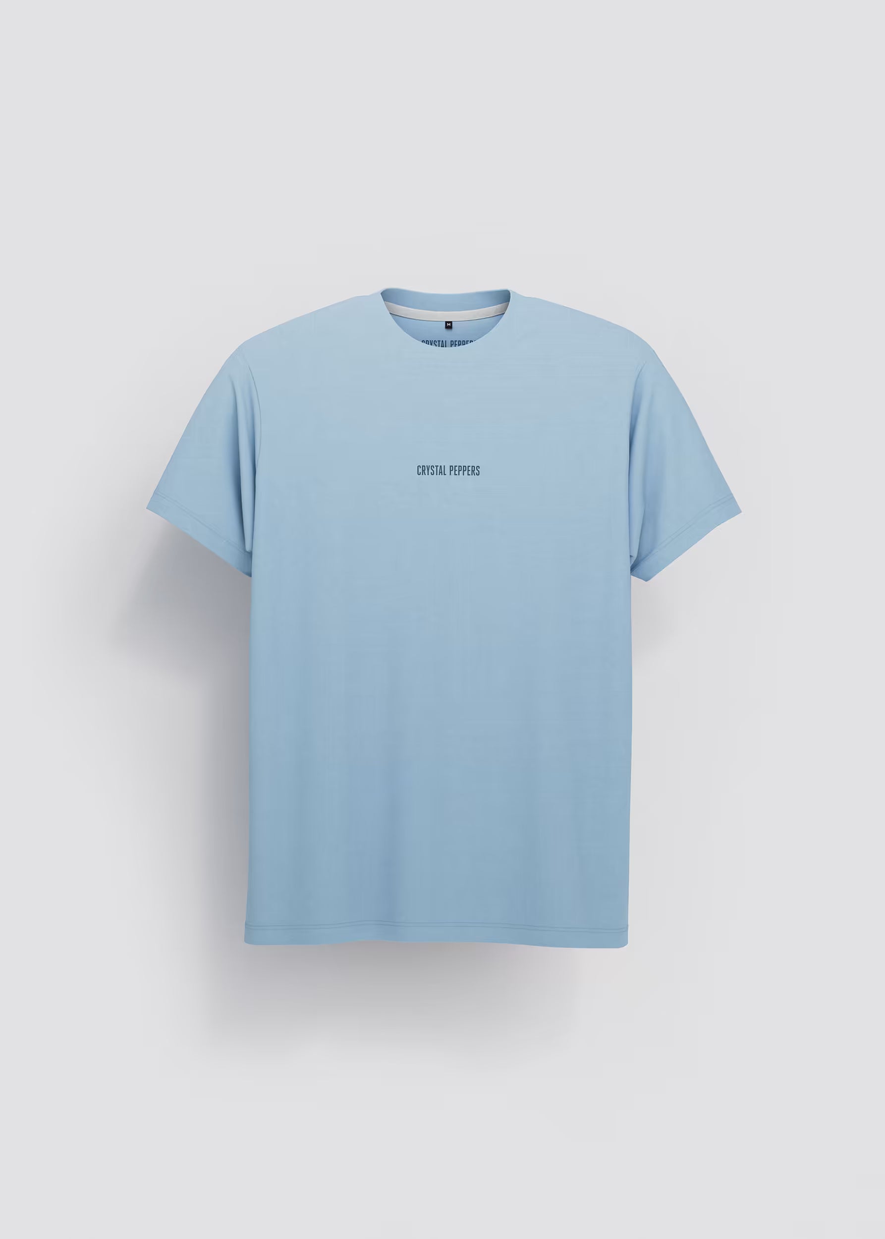 Camiseta azul celeste Never Runs Out of Fuel — vista frontal con logo Crystal Peppers centrado en el pecho