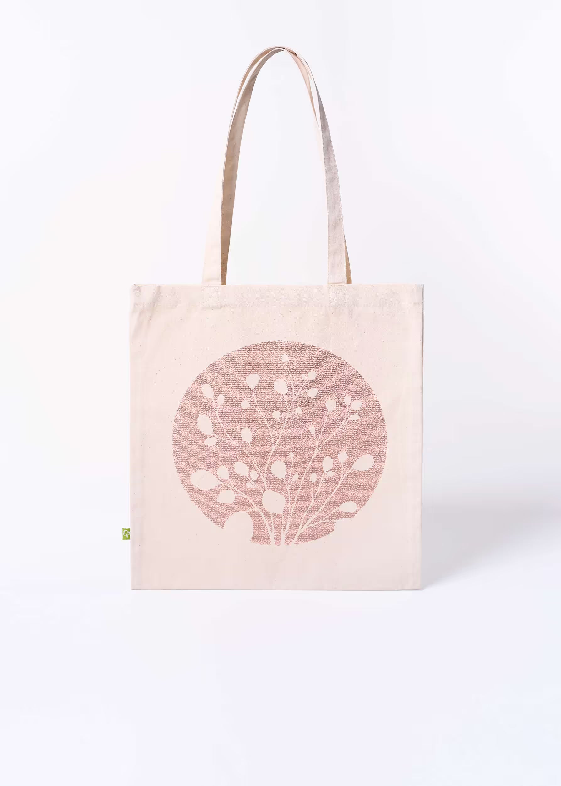 Tote bag Arena Roja Crystal Peppers — vista frontal con motivo botánico serigrafiado en arena roja sobre lienzo natural, etiqueta ecológica verde