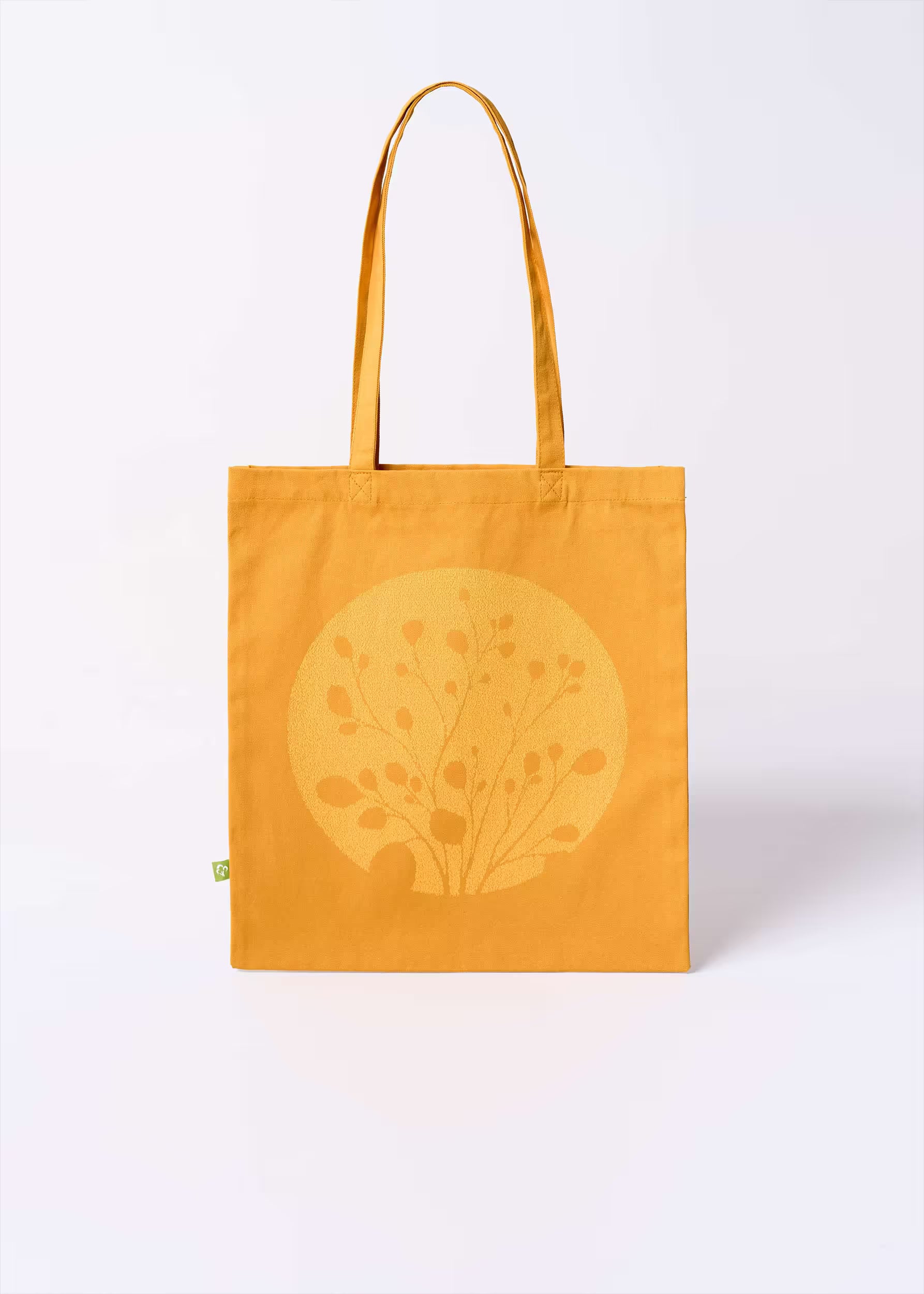 Tote bag Gold Nugget Crystal Peppers — vista frontal con motivo botánico serigrafiado tono sobre tono, etiqueta ecológica verde